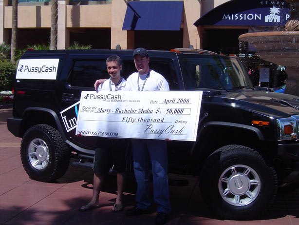 Marty S., winner of the $50,000 prize and Adam in front of one of the 2 H Bomb Hummers, the next big promotional prize from PussyCash.