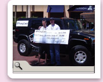 Marty S., winner of the $50,000 prize and Adam in front of one of the 2 H Bomb Hummers, the next big promotional prize from PussyCash.